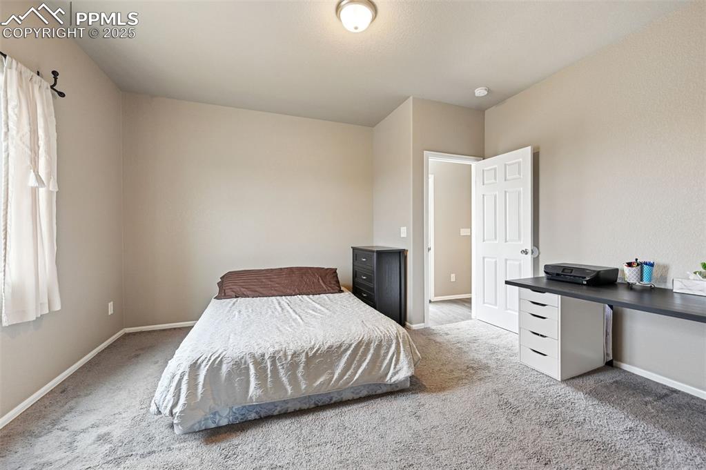Image 11 of 29: Carpeted bedroom featuring baseboards