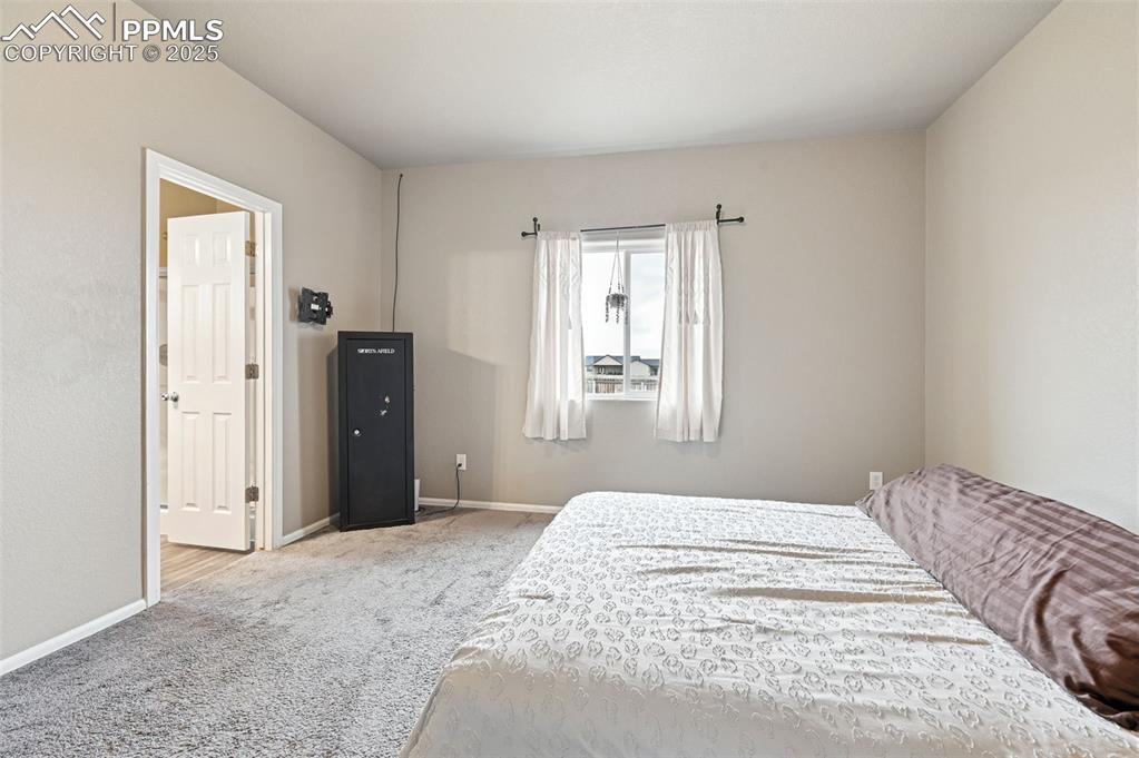 Image 12 of 29: Carpeted bedroom with baseboards