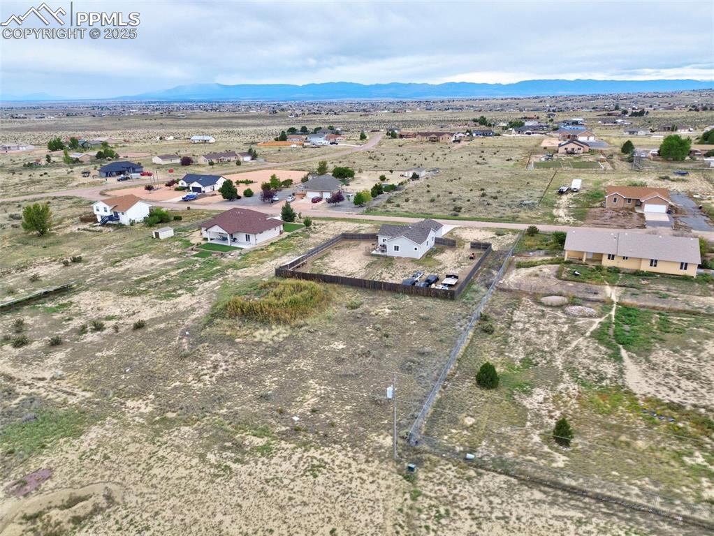 Image 27 of 29: Overview of rural landscape featuring nearby suburban area and mountains