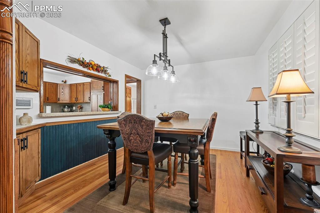 Image 21 of 46: Dining area featuring light wood-type flooring and baseboards
