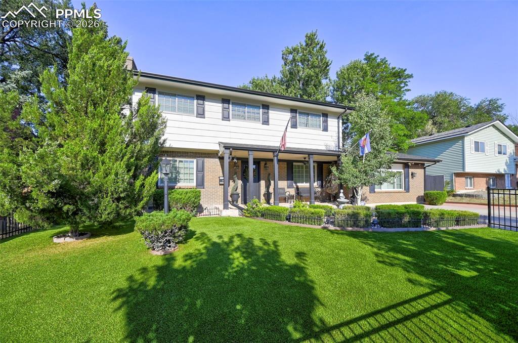 Image 3 of 46: View of front facade with a patio area and brick siding