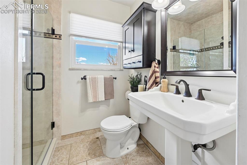 Image 38 of 46: Bathroom with toilet and a shower stall