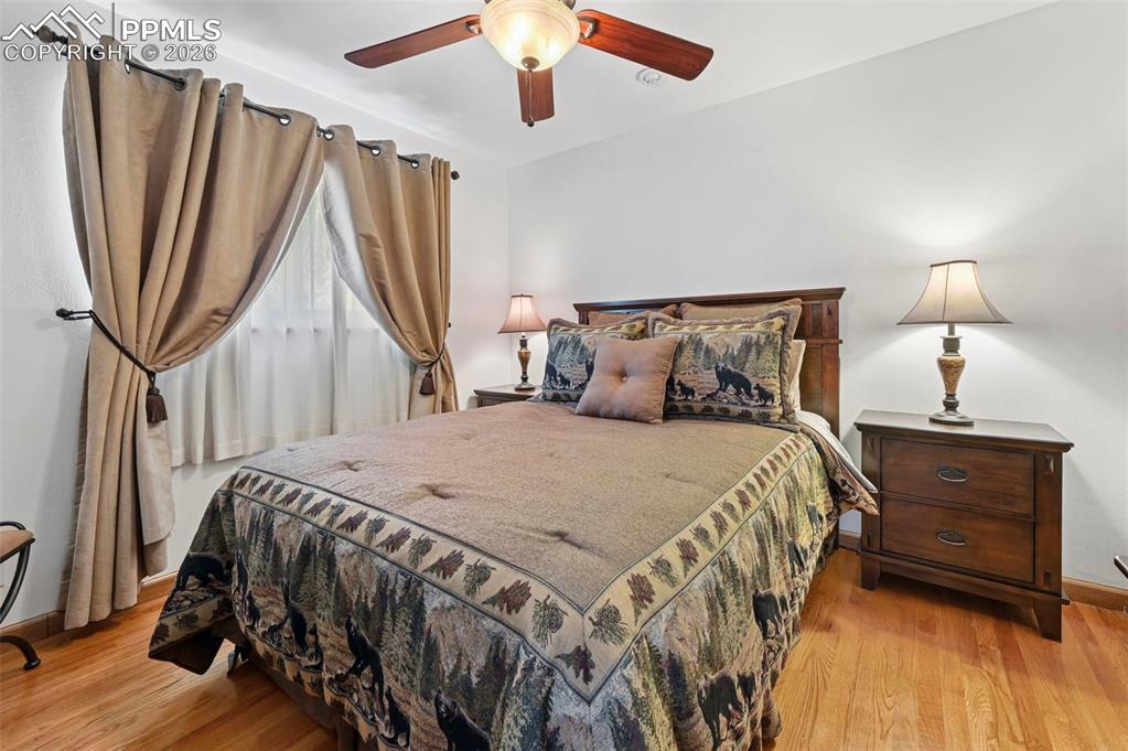 Image 41 of 46: Bedroom with light wood-style floors and ceiling fan