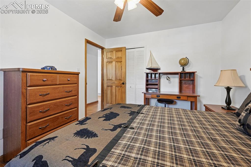 Image 44 of 46: Bedroom with a closet, a ceiling fan, and wood finished floors