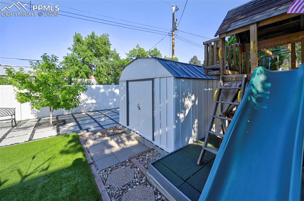Image 7 of 46: View of shed with a fenced backyard