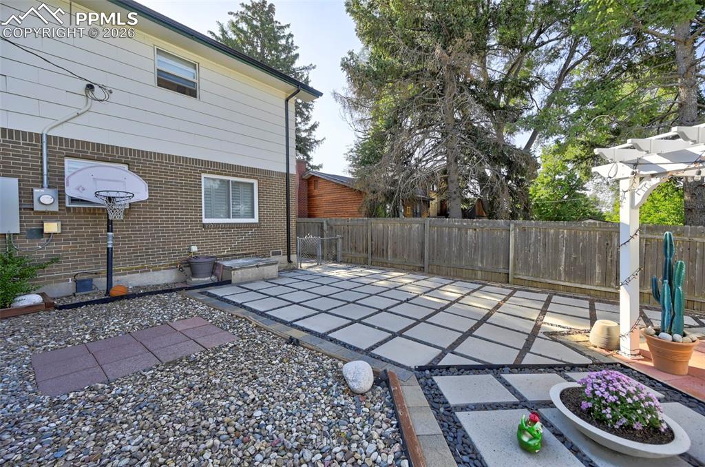 Image 9 of 46: Fenced backyard featuring a patio area