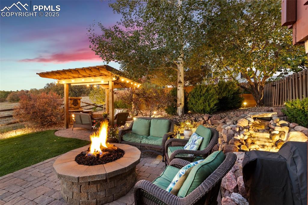 Image 2 of 46: View of patio / terrace featuring a pergola, water feature and outdoor loun