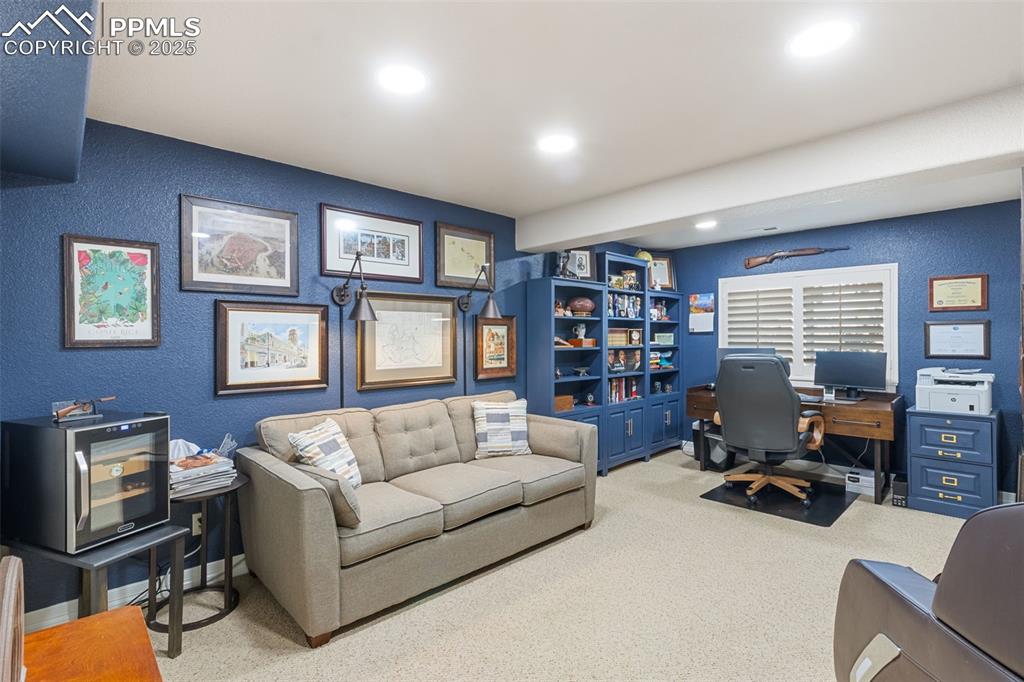 Image 31 of 46: Home office with a textured wall, carpet, and recessed lighting
