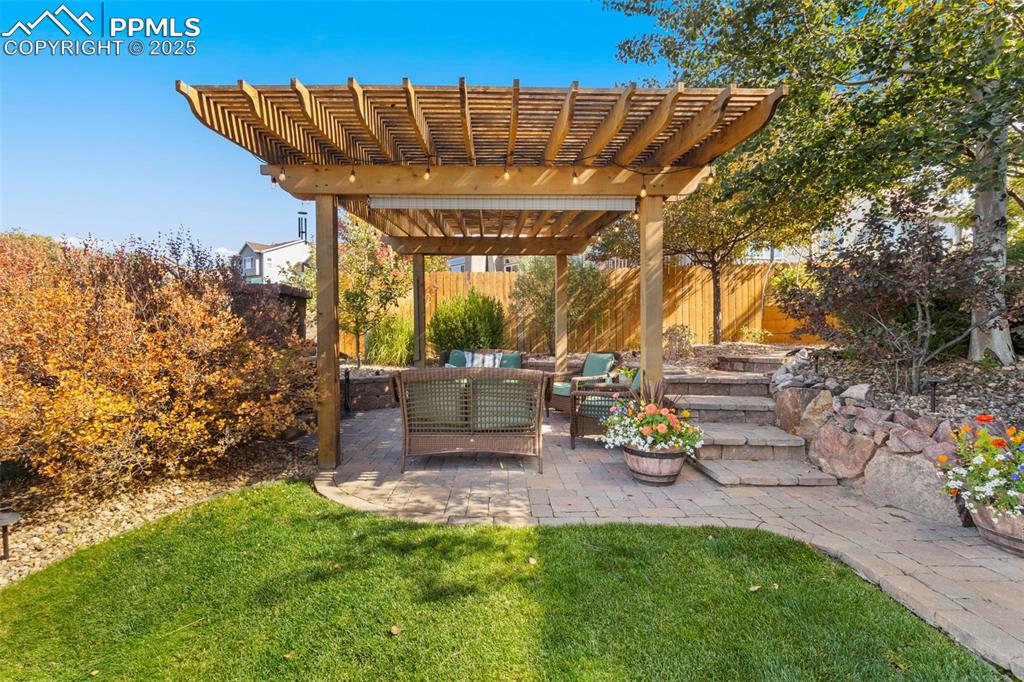 Image 38 of 46: View of yard with an outdoor hangout area, a patio, and a pergola