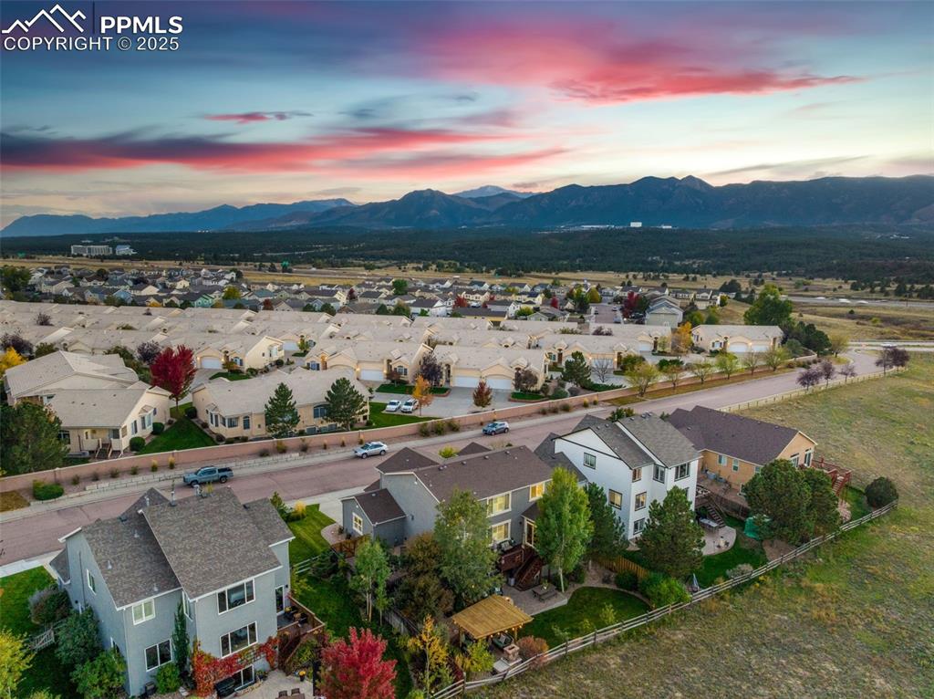 Image 42 of 46: Aerial perspective of suburban area featuring a mountain backdrop