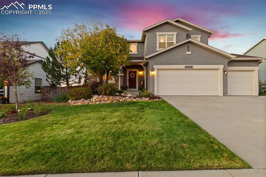 Image 45 of 46: Traditional-style home with stucco siding and concrete driveway