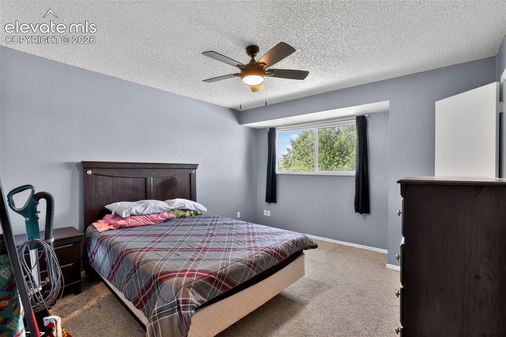 Image 18 of 28: Carpeted room featuring light blue walls and a textured ceiling