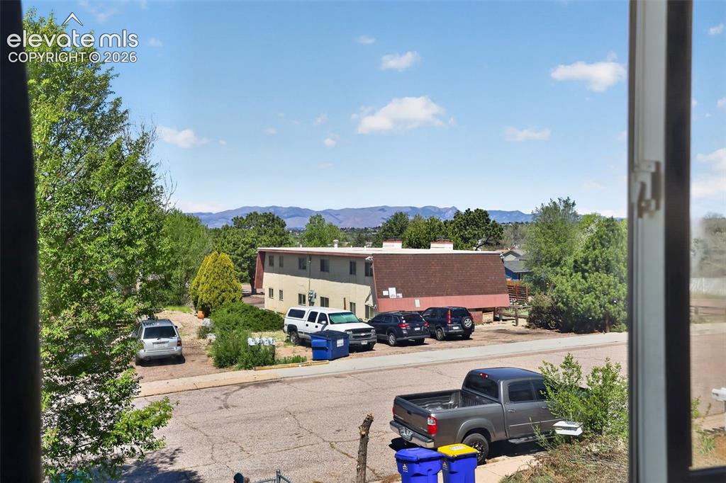 Image 2 of 28: Expansive mountain range backdrop visible from the property