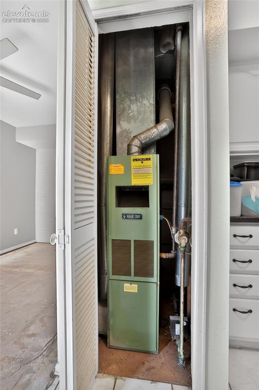 Image 22 of 28: Utility closet featuring a residential furnace unit with exposed ductwork a