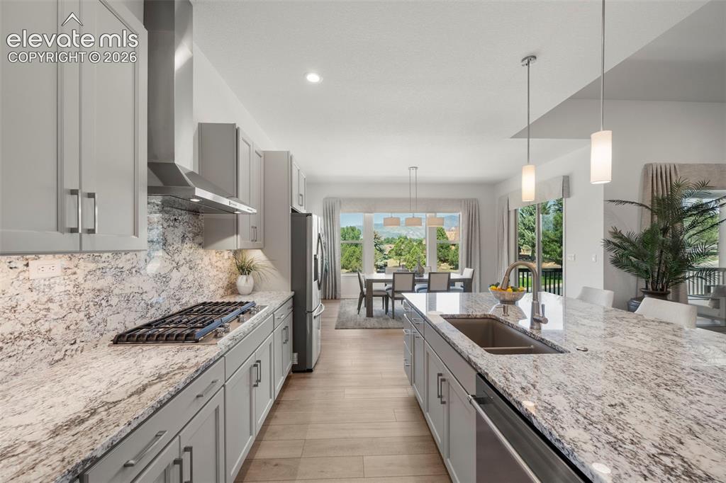 Image 15 of 50: Kitchen featuring light-toned cabinetry, stainless steel appliances, a gas