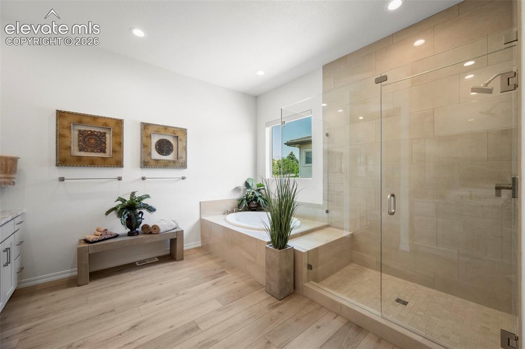 Image 21 of 50: Walk-in shower with clear glass enclosure and tiled walls