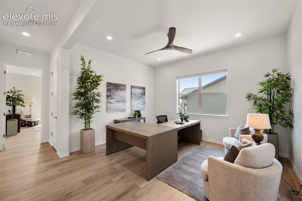 Image 22 of 50: Recessed lighting, wood-finish flooring, a contemporary ceiling fan, and a 