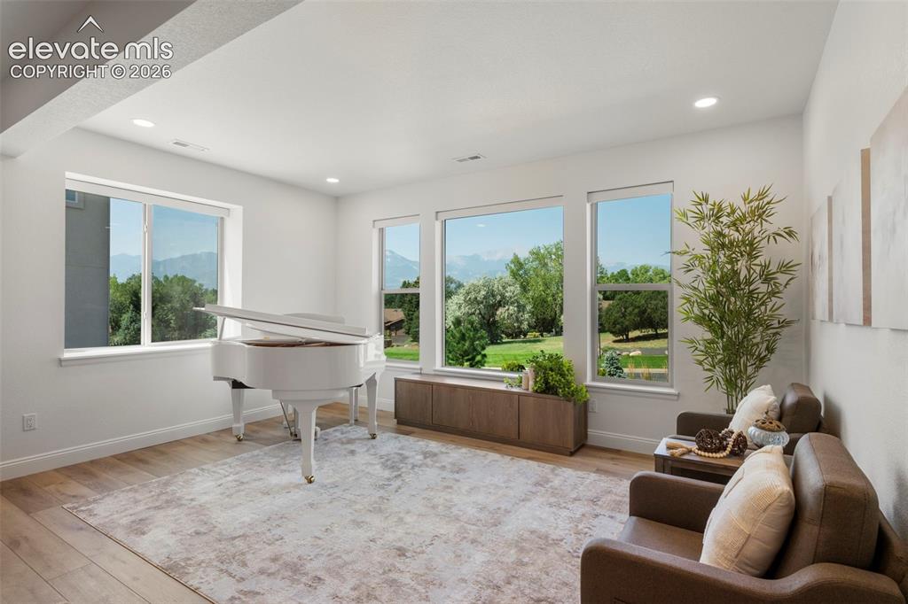 Image 30 of 50: Recessed lighting, wood-finish flooring, white walls, and multiple windows 