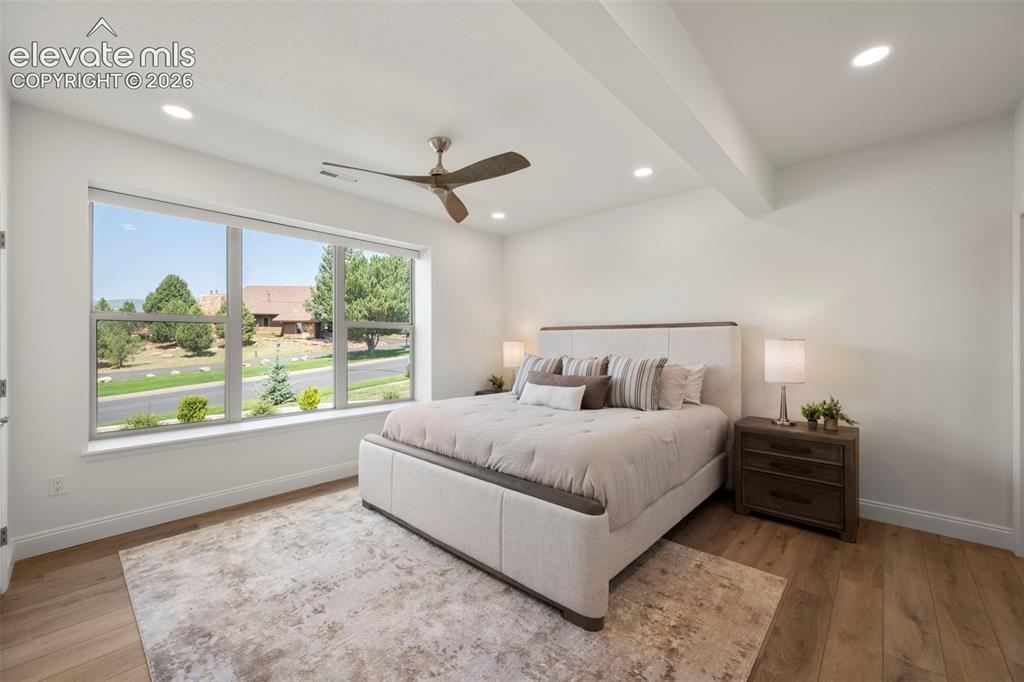 Image 37 of 50: Expansive window offering abundant natural light, recessed lighting, wood-b
