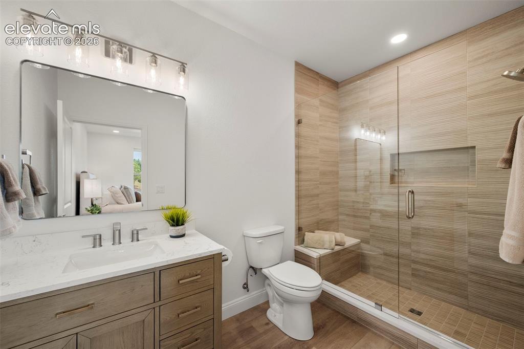 Image 38 of 50: Shower with a glass enclosure, a built-in bench, and a recessed niche