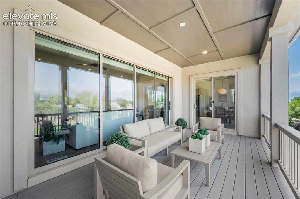 Image 40 of 50: Covered outdoor deck with spectacular mountain and Pikes Peak views