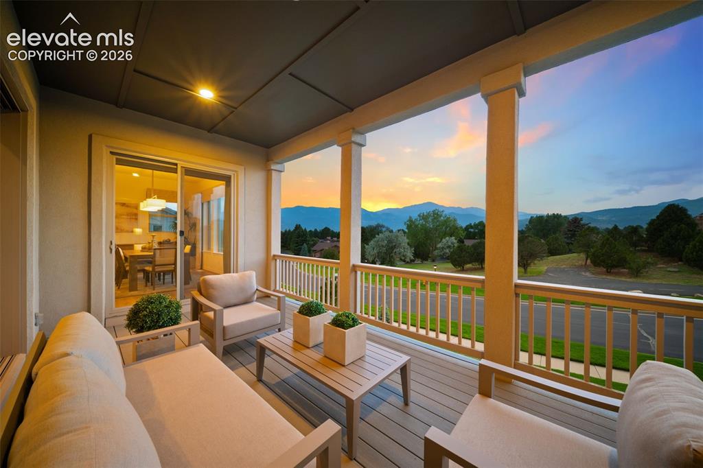 Image 41 of 50: Covered outdoor deck with spectacular mountain and Pikes Peak views