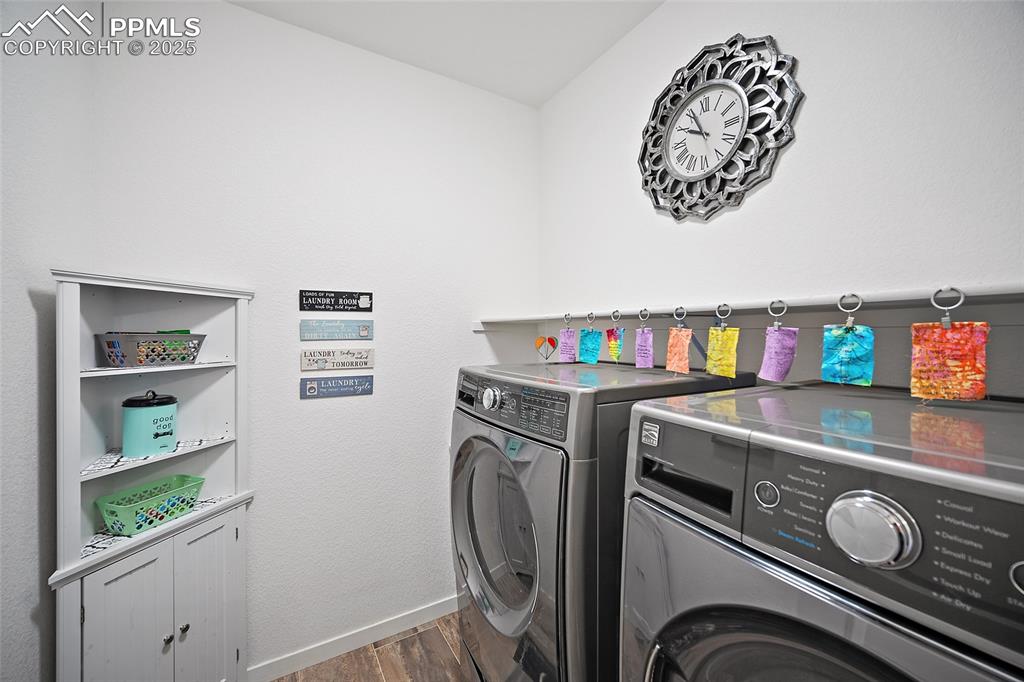 Image 11 of 41: Laundry area featuring independent washer and dryer, dark wood-type floorin