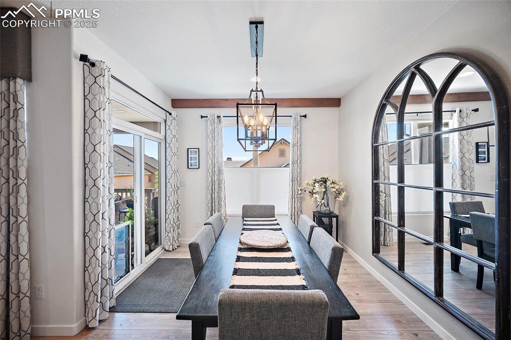 Image 12 of 41: Dining space with a chandelier and wood finished floors