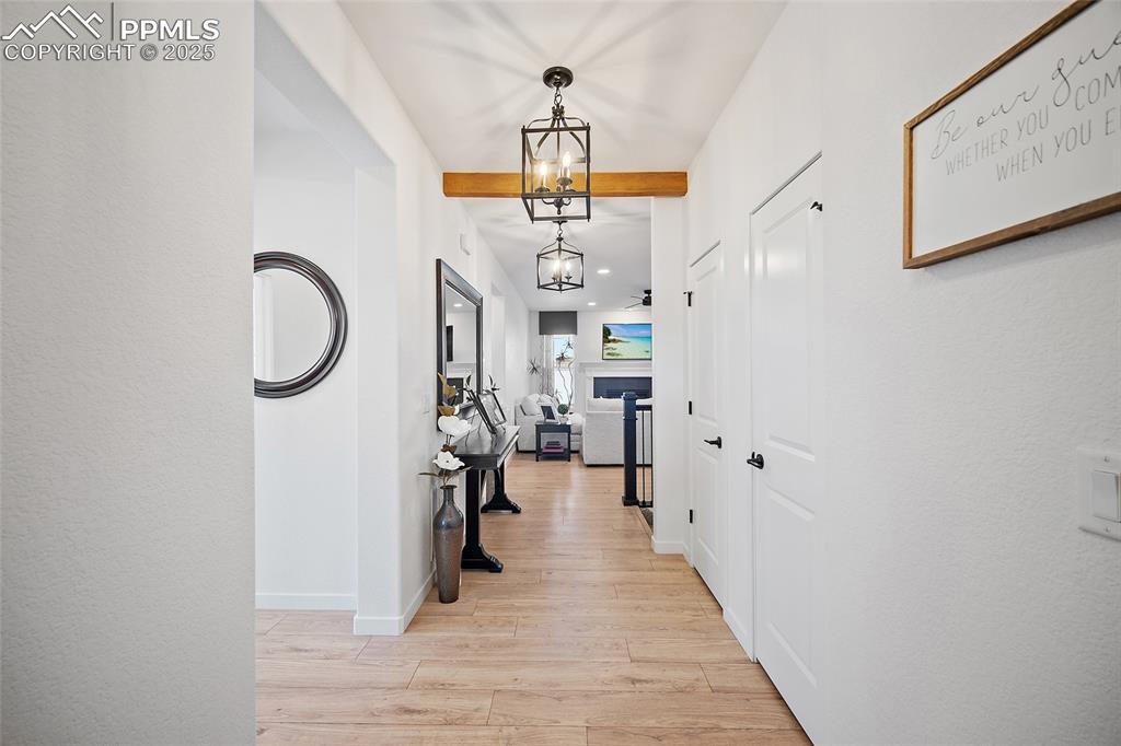 Image 13 of 41: Hall featuring light wood-type flooring, recessed lighting, and beamed ceil