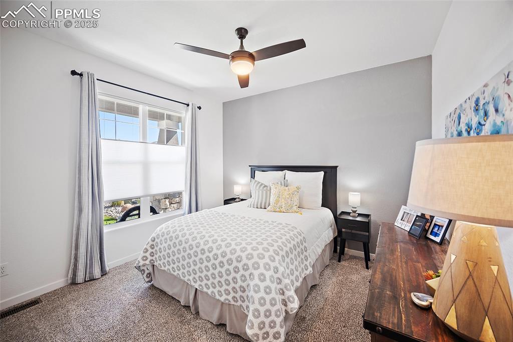 Image 14 of 41: Bedroom with ceiling fan and carpet flooring