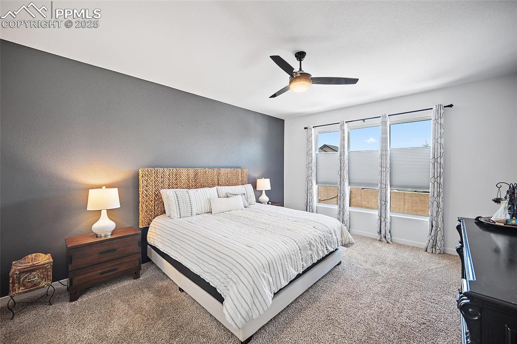 Image 19 of 41: Carpeted bedroom featuring a ceiling fan and baseboards
