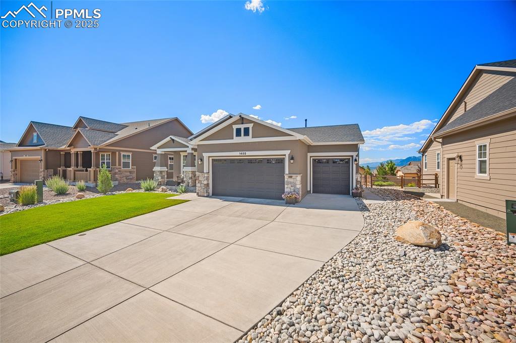 Image 2 of 41: View of front of house featuring a garage, concrete driveway, stucco siding