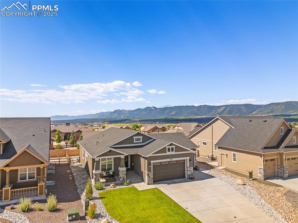 Image 22 of 41: Craftsman inspired home with stone siding, a mountain view, a garage, drive