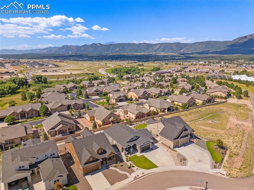 Image 26 of 41: Aerial perspective of suburban area featuring a mountainous background