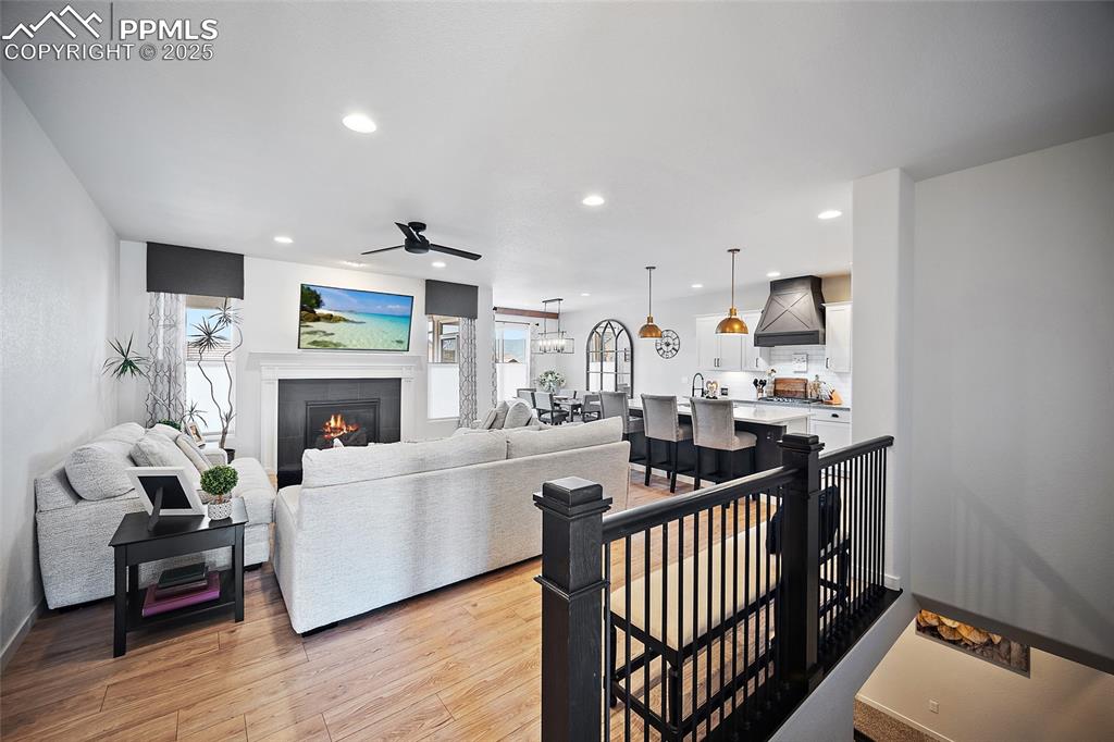 Image 27 of 41: Living area with recessed lighting, ceiling fan, light wood-style floors, a
