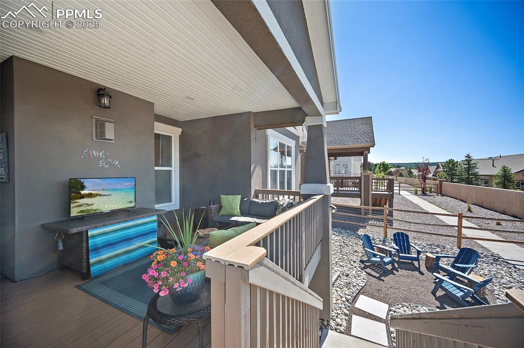 Image 31 of 41: Wooden deck with a fenced backyard