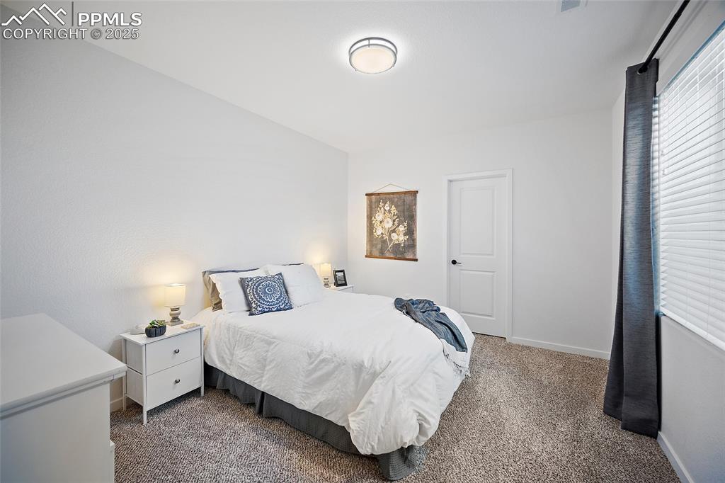 Image 32 of 41: Carpeted bedroom with baseboards