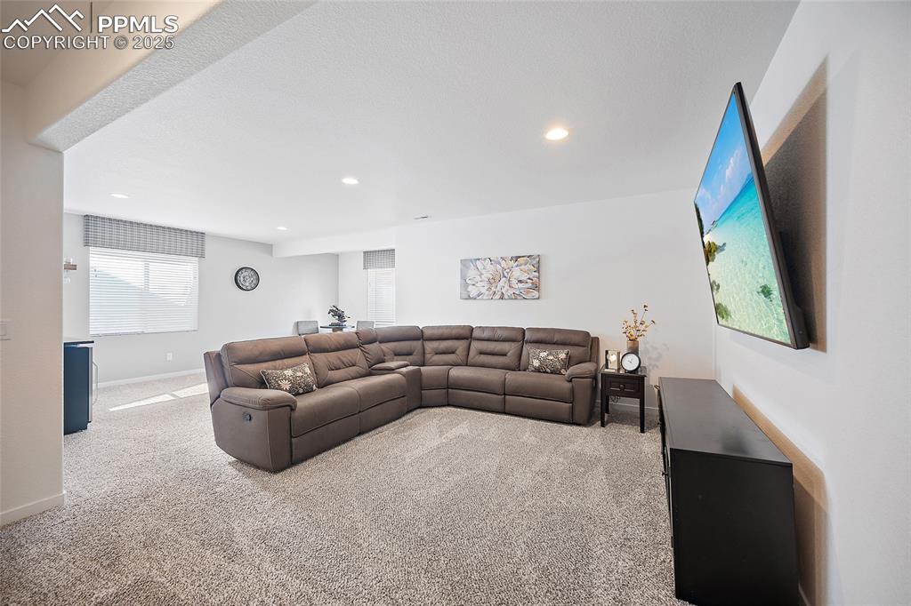 Image 35 of 41: Living area featuring carpet flooring and recessed lighting