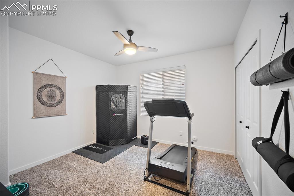 Image 38 of 41: Workout room featuring a ceiling fan and carpet