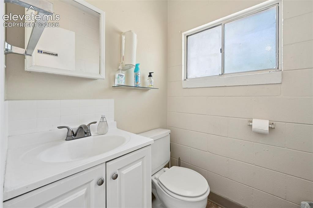 Image 13 of 23: White vanity with dual-door cabinetry and brushed nickel hardware