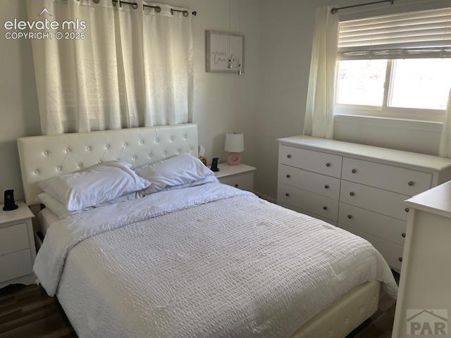 Image 11 of 19: Room featuring wood-finish flooring and light-toned walls