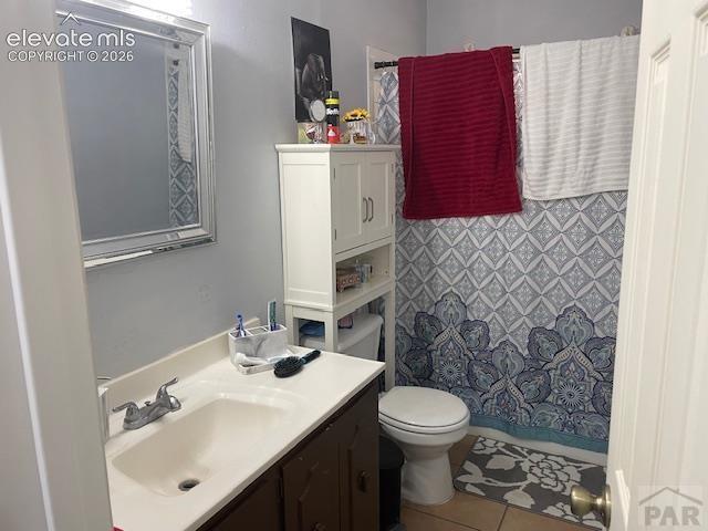 Image 12 of 19: Bathroom featuring a vanity with a white countertop and dark wood-finish ca