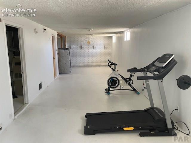 Image 13 of 19: Spacious room featuring white painted walls and light-colored flooring
