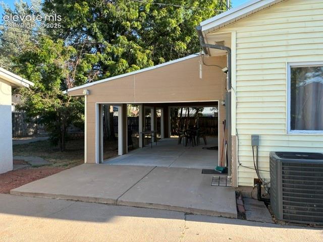 Image 15 of 19: Covered patio side view