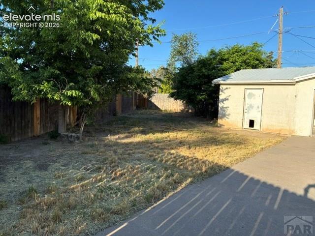 Image 4 of 19: Spacious backyard featuring a storage shed with a metal roof, concrete pati