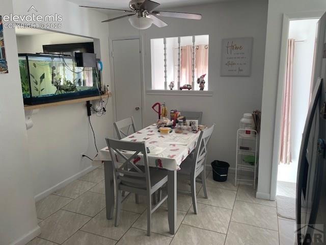 Image 7 of 19: Dining area featuring light-toned tile flooring and an overhead ceiling fan