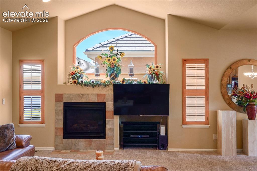 Image 11 of 36: Vaulted ceilings and gas fireplace in the living room