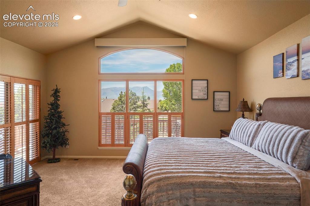 Image 13 of 36: Primary bedroom with vaulted ceiling and amazing views