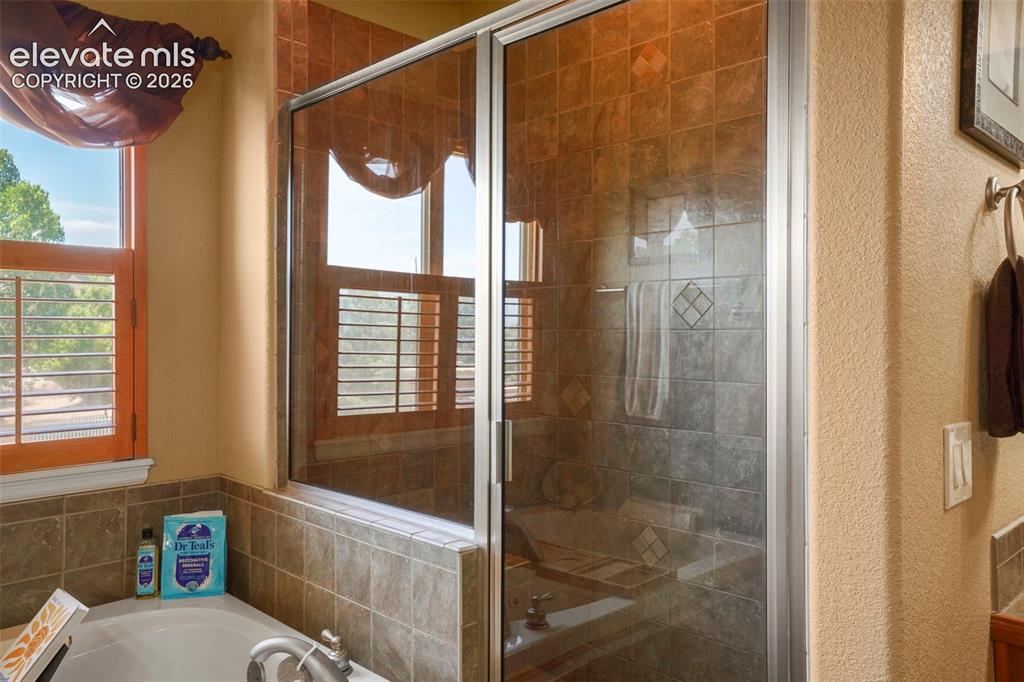 Image 18 of 36: Separate walk-in shower in primary bath