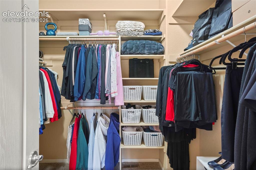 Image 19 of 36: Large walk-in closet in primary bedroom